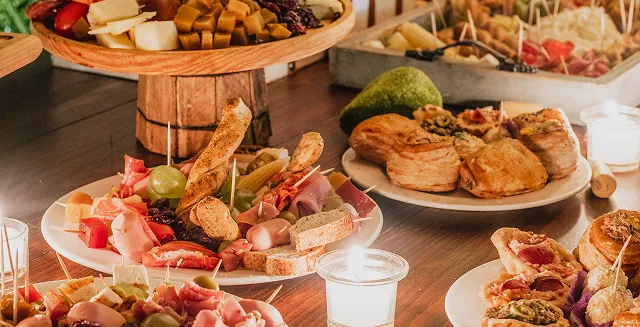 Assorted food platters displayed on a catering table.
