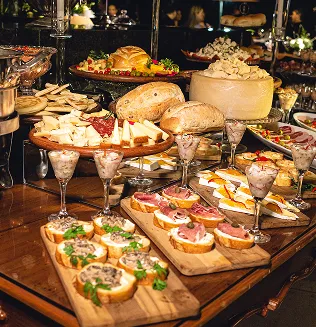 A catering display featuring assorted appetizers and desserts.