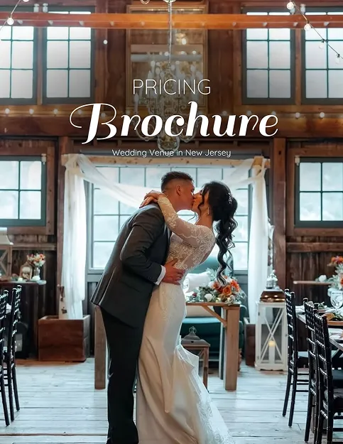 Newlyweds kissing inside a barn reception hall in a brochure cover